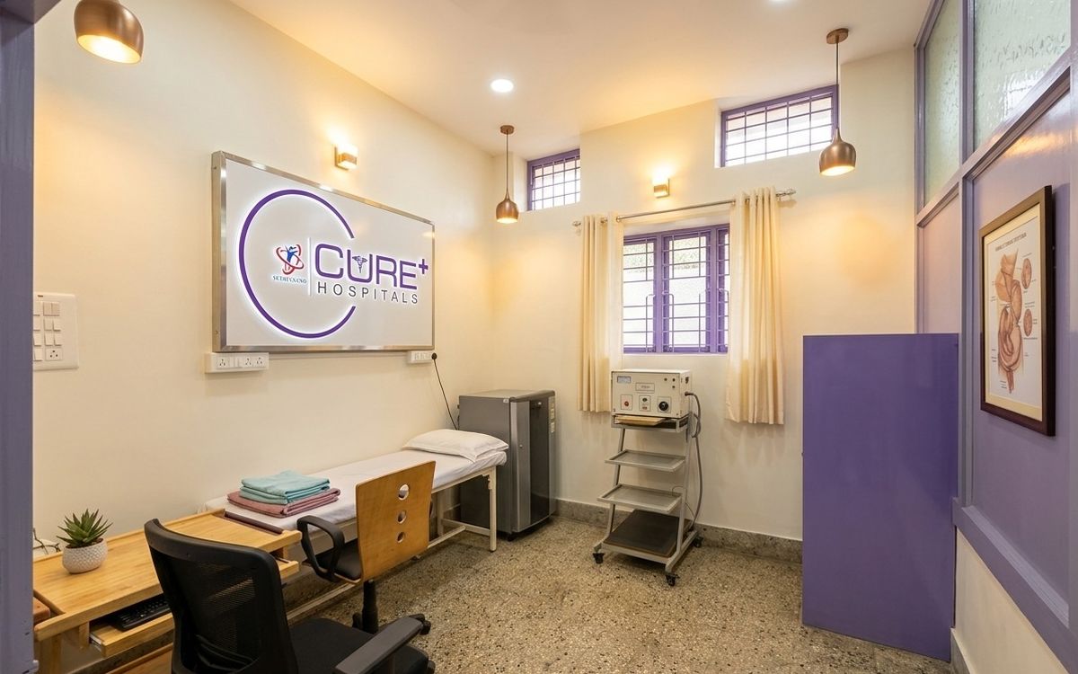 Examination room with the CurePlus logo wall